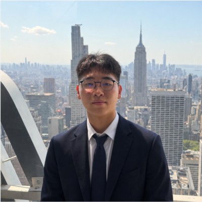 Jack J. Liu in a navy suit, with the New York City skyline behind him
