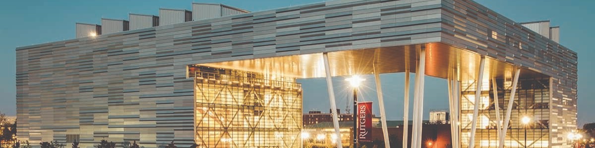 The Rutgers Business School building lit up at dusk